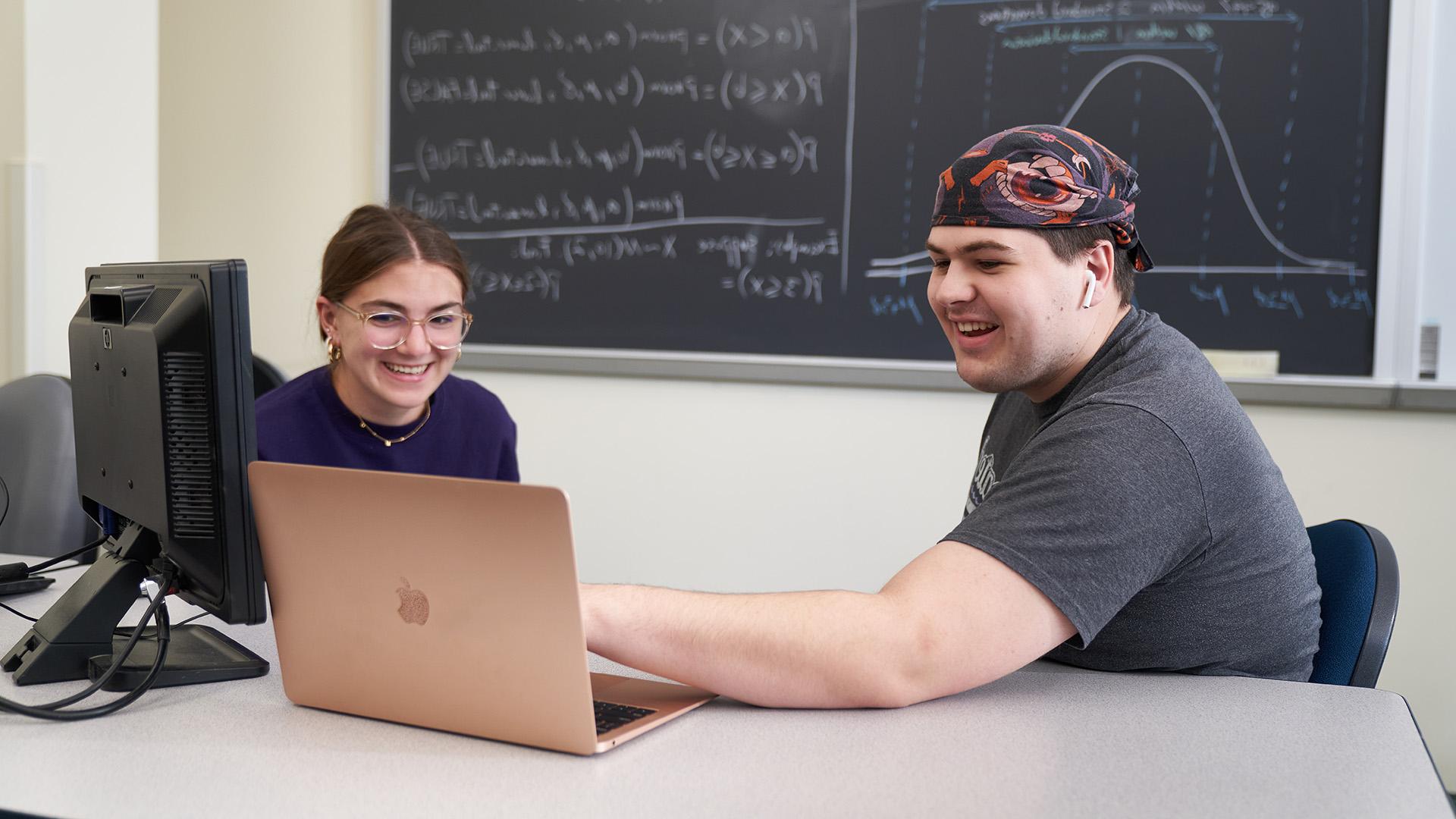 Academic Advisor with student at laptop